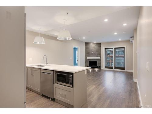 401-741 Travino Lane, Saanich, BC - Indoor Photo Showing Kitchen With Fireplace