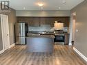 110 - 299 Cundles Road E, Barrie, ON  - Indoor Photo Showing Kitchen With Stainless Steel Kitchen With Double Sink 