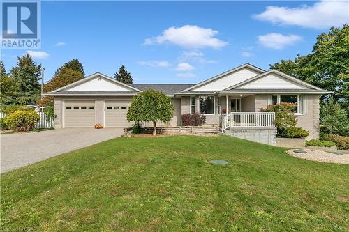 Ranch-style house with a garage, covered porch, and a front lawn - 5819 Wellington Cty Rd 7, Guelph, ON 