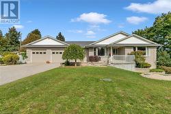 Ranch-style house with a garage, covered porch, and a front lawn - 