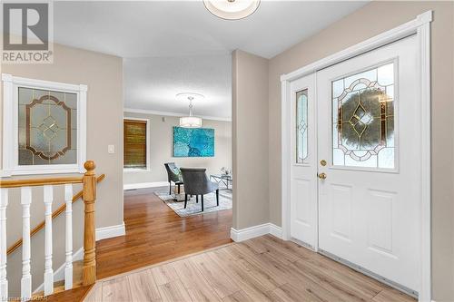 Foyer with a textured ceiling, light hardwood / wood-style floors, crown molding, and a healthy amount of sunlight - 5819 Wellington Cty Rd 7, Guelph, ON 