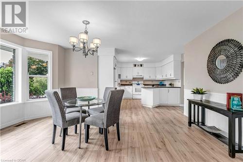 Dining area featuring light hardwood / wood-style floors and an inviting chandelier - 5819 Wellington Cty Rd 7, Guelph, ON 