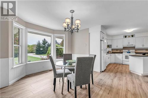 Dining space featuring light hardwood / wood-style flooring and an inviting chandelier - 5819 Wellington Cty Rd 7, Guelph, ON 