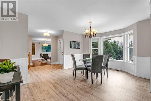 Dining room featuring light hardwood / wood-style flooring and a notable chandelier - 5819 Wellington Cty Rd 7, Guelph, ON 