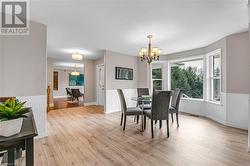 Dining room featuring light hardwood / wood-style flooring and a notable chandelier - 