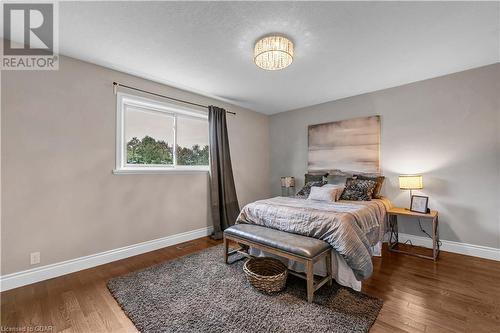 Bedroom with dark hardwood / wood-style flooring - 5819 Wellington Cty Rd 7, Guelph, ON 