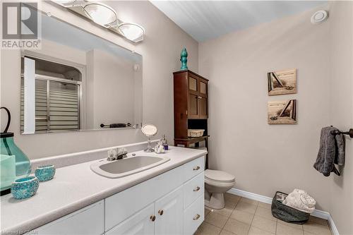 Bathroom with tile patterned flooring, vanity, toilet, and a shower with shower door - 5819 Wellington Cty Rd 7, Guelph, ON 