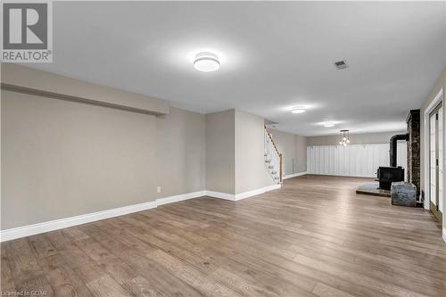 Basement featuring light wood-type flooring and a wood stove - 5819 Wellington Cty Rd 7, Guelph, ON 