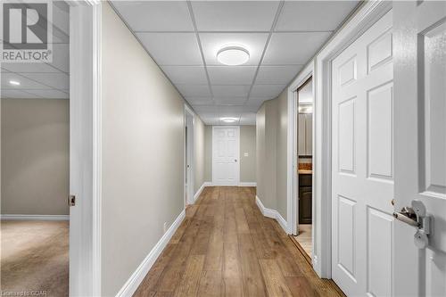 Corridor featuring a drop ceiling and hardwood / wood-style flooring - 5819 Wellington Cty Rd 7, Guelph, ON 