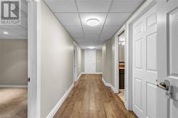 Corridor featuring a drop ceiling and hardwood / wood-style flooring - 