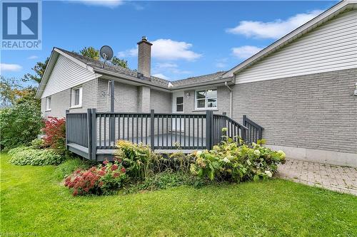 Rear view of property featuring a deck and a lawn - 5819 Wellington Cty Rd 7, Guelph, ON 