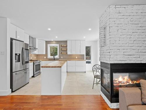 Kitchen - 200 Rue Dessureault, Mont-Tremblant, QC - Indoor Photo Showing Kitchen With Fireplace With Upgraded Kitchen