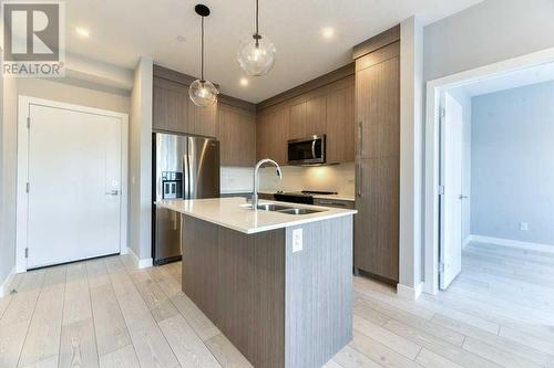 1208, 111 Wolf Creek Drive, Calgary, AB - Indoor Photo Showing Kitchen With Double Sink With Upgraded Kitchen