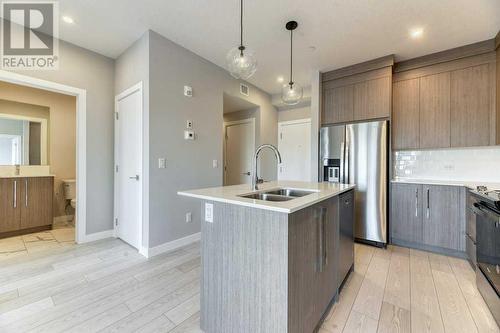 1208, 111 Wolf Creek Drive, Calgary, AB - Indoor Photo Showing Kitchen With Stainless Steel Kitchen With Double Sink With Upgraded Kitchen