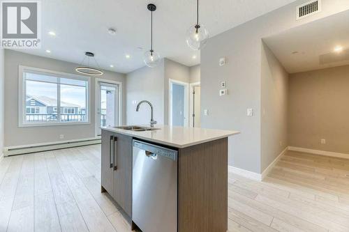 1208, 111 Wolf Creek Drive, Calgary, AB - Indoor Photo Showing Kitchen With Double Sink With Upgraded Kitchen