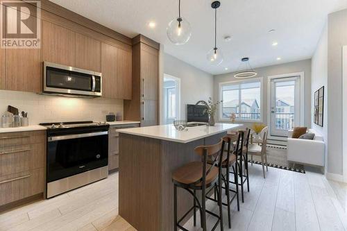 1208, 111 Wolf Creek Drive, Calgary, AB - Indoor Photo Showing Kitchen With Upgraded Kitchen