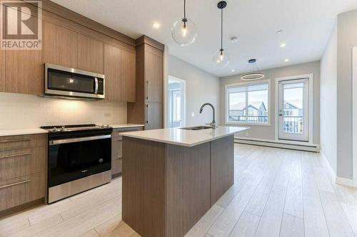 1208, 111 Wolf Creek Drive, Calgary, AB - Indoor Photo Showing Kitchen With Upgraded Kitchen