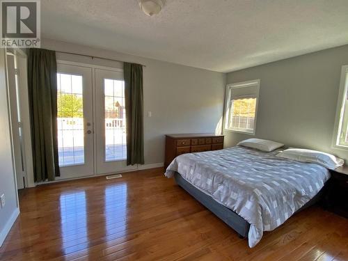 Master Bedroom with Garden Door to Backyard Deck - 709 Stone Road, Barriere, BC - Indoor Photo Showing Bedroom