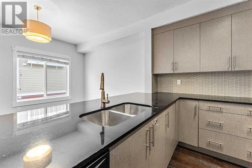 52 West Caoch Manor Sw, Calgary, AB - Indoor Photo Showing Kitchen With Double Sink