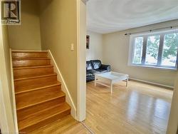 Staircase with hardwood / wood-style flooring - 