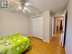 Unfurnished bedroom with light hardwood / wood-style floors, a closet, and ceiling fan - 