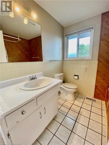 Bathroom featuring tile patterned floors, vanity, tile walls, and toilet - 531 Brookhaven Crescent Unit# A, Waterloo, ON - Indoor Photo Showing Bathroom