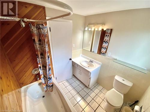 Full bathroom featuring vanity, tile patterned floors, toilet, shower / bathtub combination with curtain, and tile walls - 531 Brookhaven Crescent Unit# A, Waterloo, ON - Indoor Photo Showing Bathroom