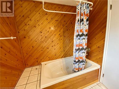 Bathroom with tile patterned floors and wood walls - 531 Brookhaven Crescent Unit# A, Waterloo, ON - Indoor