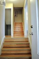 Stairway with hardwood / wood-style flooring - 