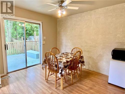 Dining room featuring ceiling fan, light hardwood / wood-style floors, and brick wall - 531 Brookhaven Crescent Unit# A, Waterloo, ON - Indoor Photo Showing Dining Room