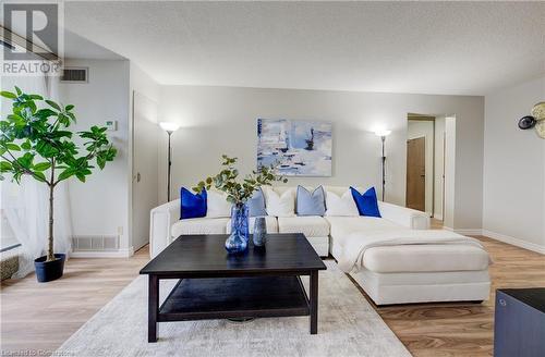 Living room with wood-type flooring and a textured ceiling - 375 King Street N Unit# 503, Waterloo, ON - Indoor Photo Showing Living Room