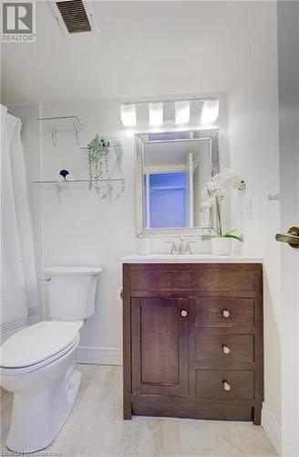 Full bathroom featuring tile patterned flooring, shower / tub combo with curtain, vanity, and toilet - 375 King Street N Unit# 503, Waterloo, ON - Indoor Photo Showing Bathroom