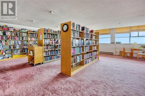 Living area featuring a textured ceiling, carpet floors, and baseboard heating - 375 King Street N Unit# 503, Waterloo, ON - Indoor