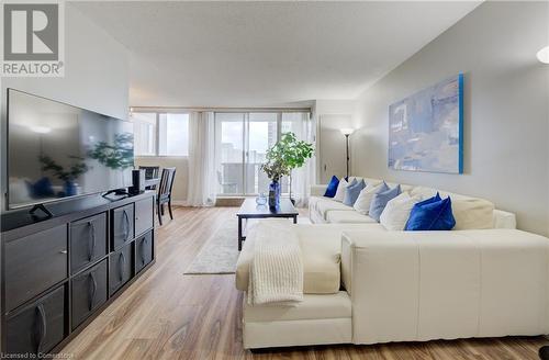 Living room featuring floor to ceiling windows, light wood-type flooring, and a textured ceiling - 375 King Street N Unit# 503, Waterloo, ON - Indoor Photo Showing Living Room