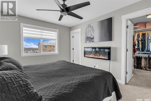 311 Delainey Manor, Saskatoon, SK - Indoor Photo Showing Bedroom With Fireplace