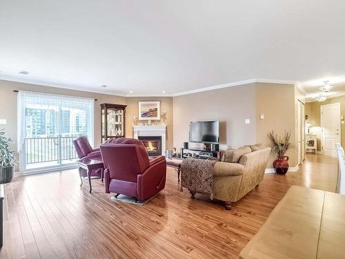 Living room - 404-225 Rue Bohémier, Mascouche, QC - Indoor Photo Showing Living Room With Fireplace