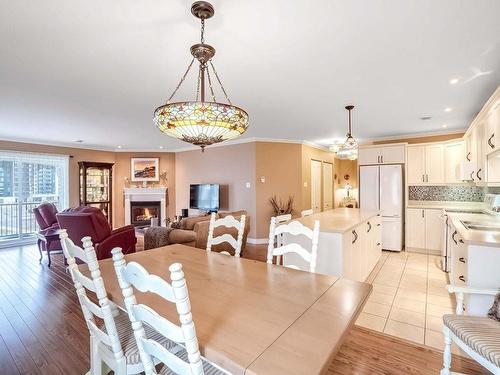 Dining room - 404-225 Rue Bohémier, Mascouche, QC - Indoor Photo Showing Dining Room With Fireplace