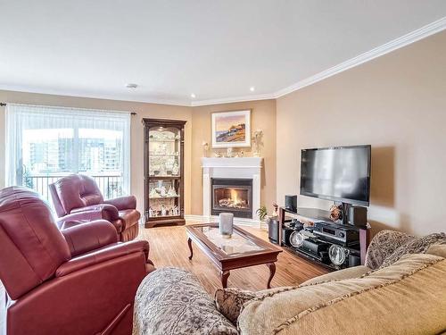 Living room - 404-225 Rue Bohémier, Mascouche, QC - Indoor Photo Showing Living Room With Fireplace