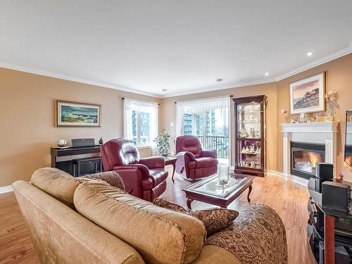 Living room - 404-225 Rue Bohémier, Mascouche, QC - Indoor Photo Showing Living Room With Fireplace