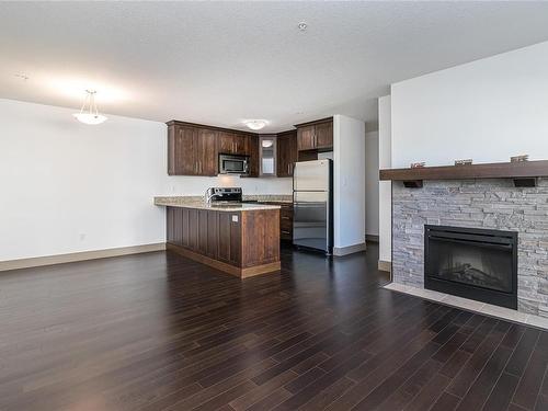 202-257 Moilliet St South, Parksville, BC - Indoor With Fireplace