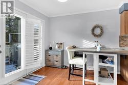 Office with crown molding and light hardwood / wood-style flooring - 