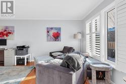 Living room featuring crown molding and light hardwood / wood-style flooring - 