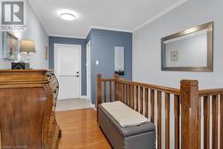 Hallway with ornamental molding and light wood-type flooring - 