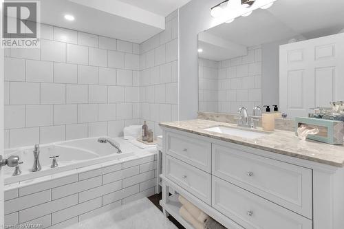 Bathroom with vanity and tiled tub - 529 Nova Scotia Court Unit# 18, Woodstock, ON - Indoor Photo Showing Bathroom