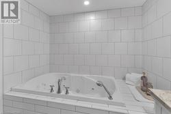 Bathroom with tiled bath and vanity - 