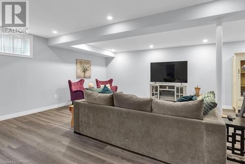 Living room featuring wood-type flooring - 529 Nova Scotia Court Unit# 18, Woodstock, ON - Indoor Photo Showing Basement