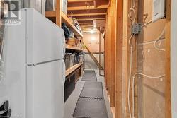 Basement featuring white fridge - 