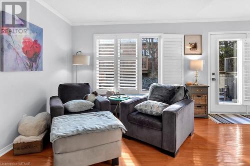 Living area with plenty of natural light, light hardwood / wood-style floors, and ornamental molding - 529 Nova Scotia Court Unit# 18, Woodstock, ON - Indoor Photo Showing Living Room