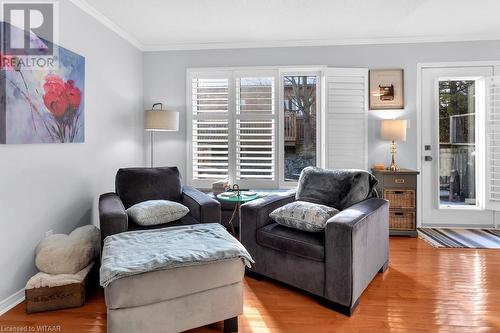 Sitting room featuring a wealth of natural light, crown molding, and hardwood / wood-style flooring - 529 Nova Scotia Court Unit# 18, Woodstock, ON - Indoor