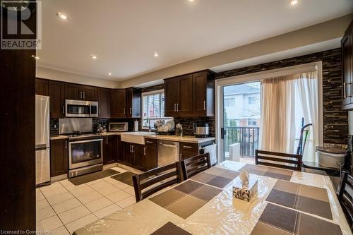 Kitchen featuring tasteful backsplash, a wealth of natural light, sink, and stainless steel appliances - 1480 Britannia Road W Unit# 143, Mississauga, ON - Indoor Photo Showing Kitchen